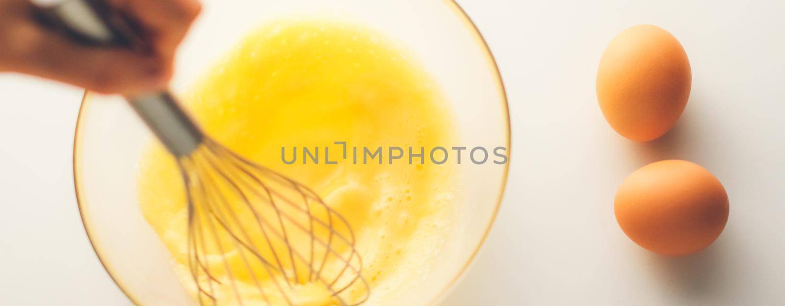 Cooking, meal and diet concept - Making of mixing eggs in bowl on marble table as homemade food flat lay, top view food brand photography flatlay and recipe for cooking blog, menu or cookbook design