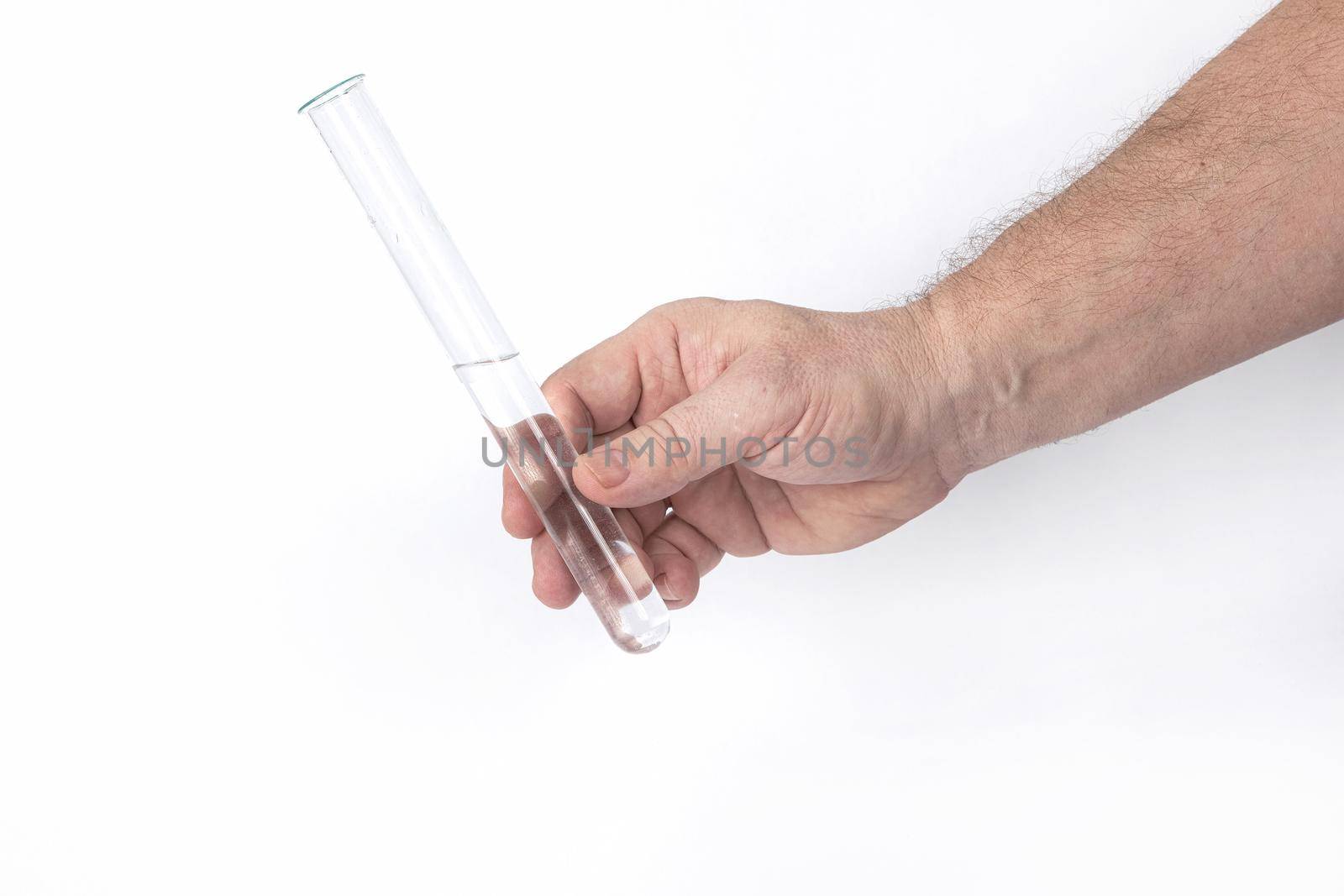 Hand holds a glass test tube with a transparent liquid on a white background, a template for designers. Close-up