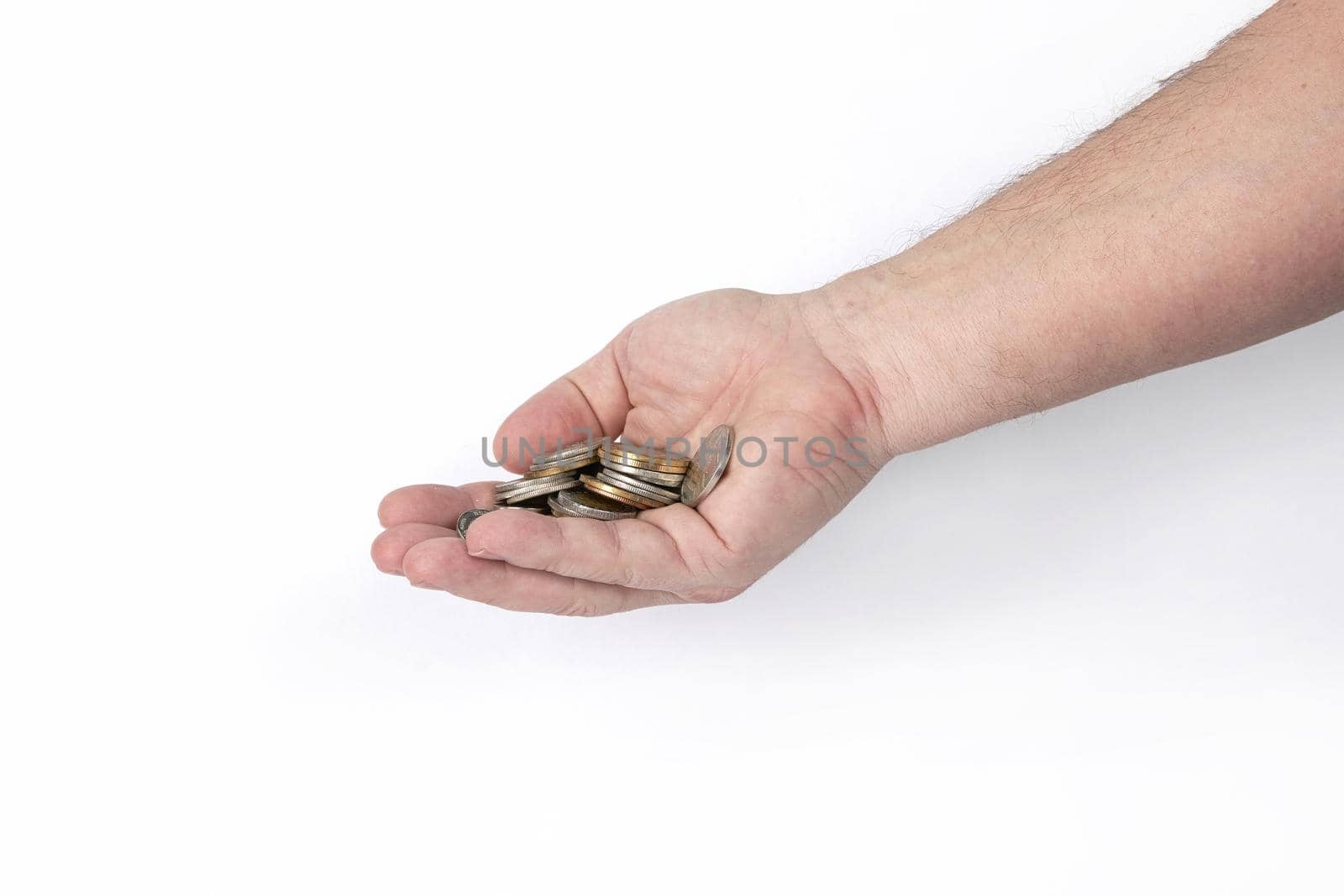 Hand holds a handful of coins on a white background, template for designers. Close up