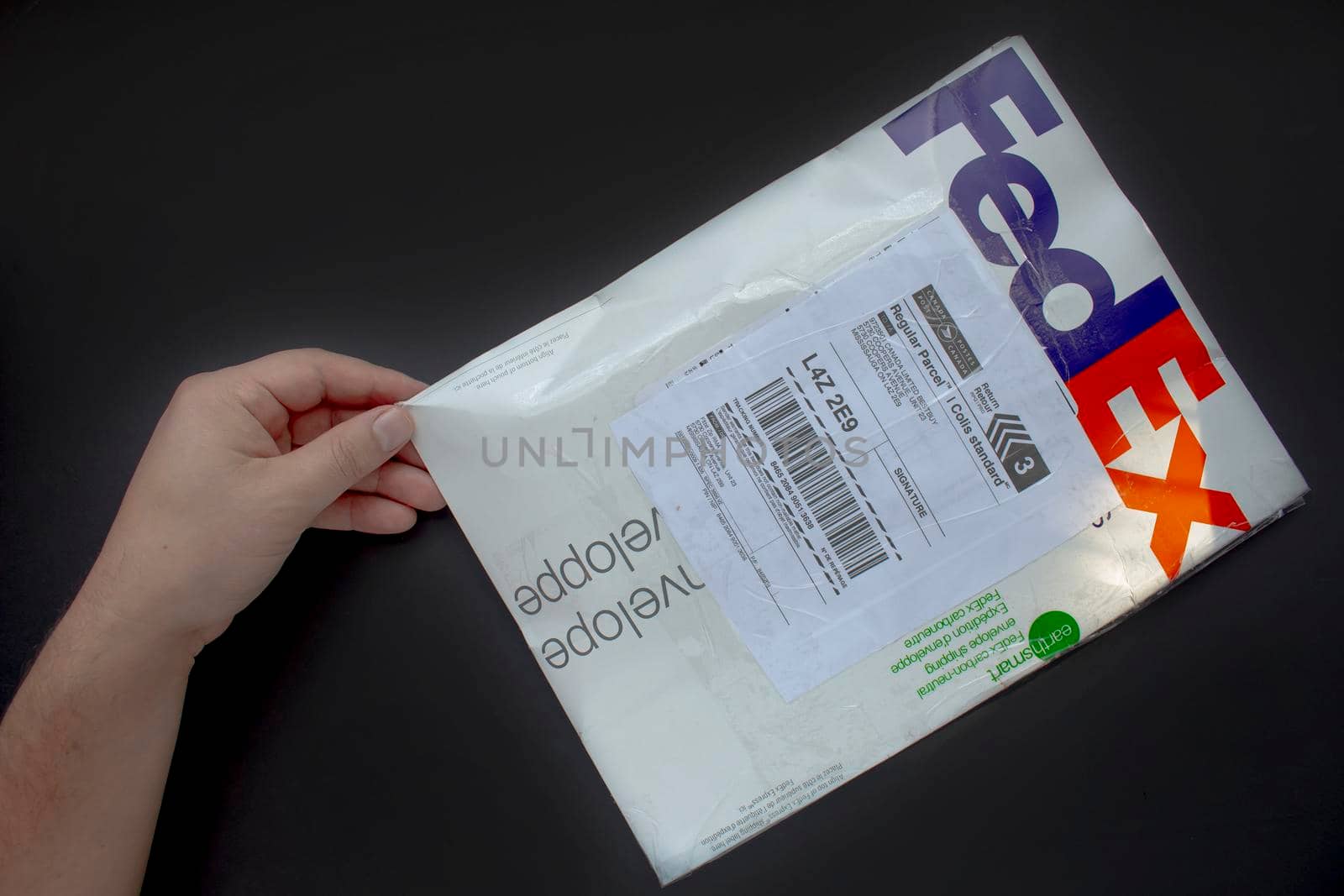 Calgary Alberta, Canada. Oct 17, 2020. A person with a Fedex package. Concept: shipping packages