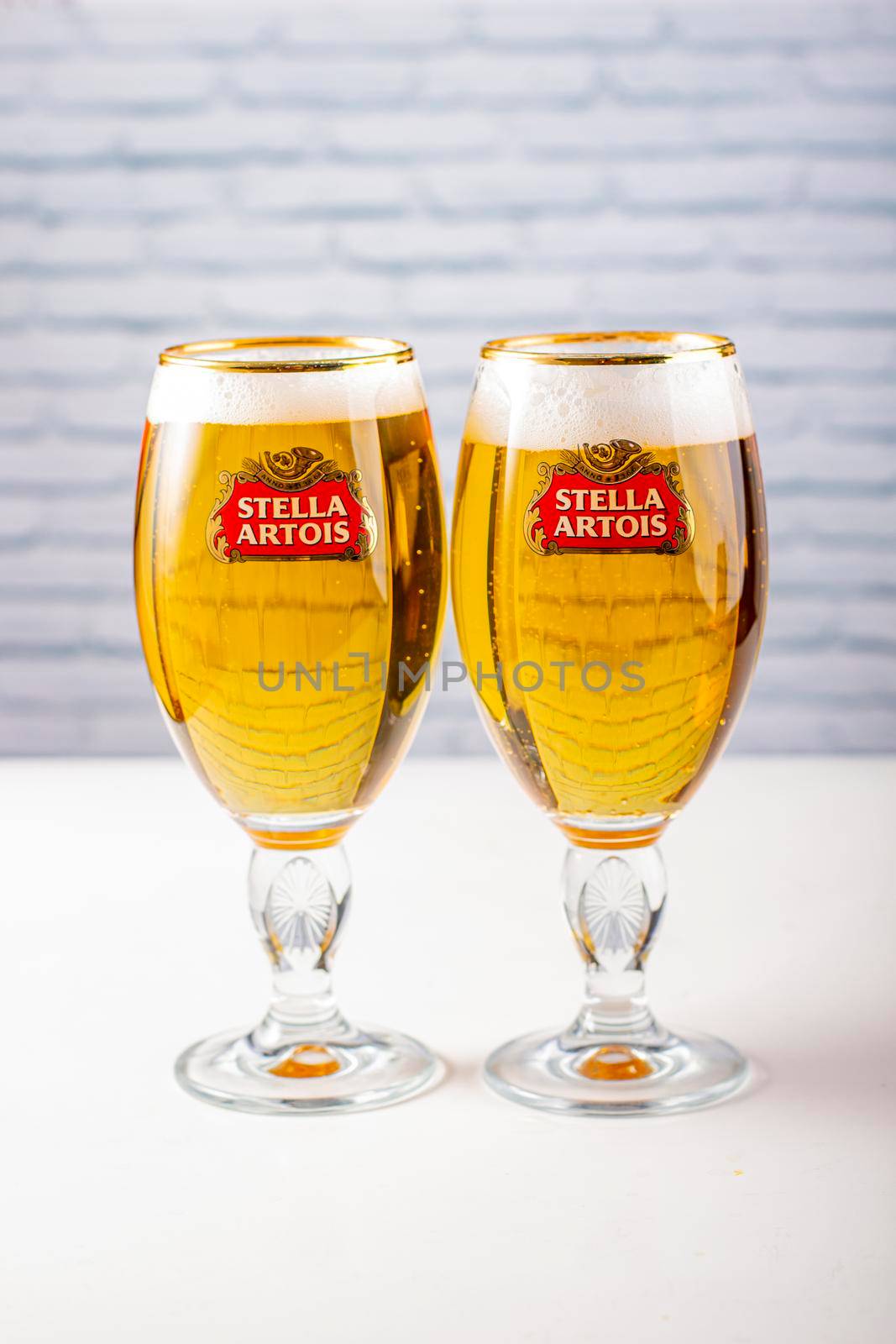 Two cups of Stella Artois full of beer