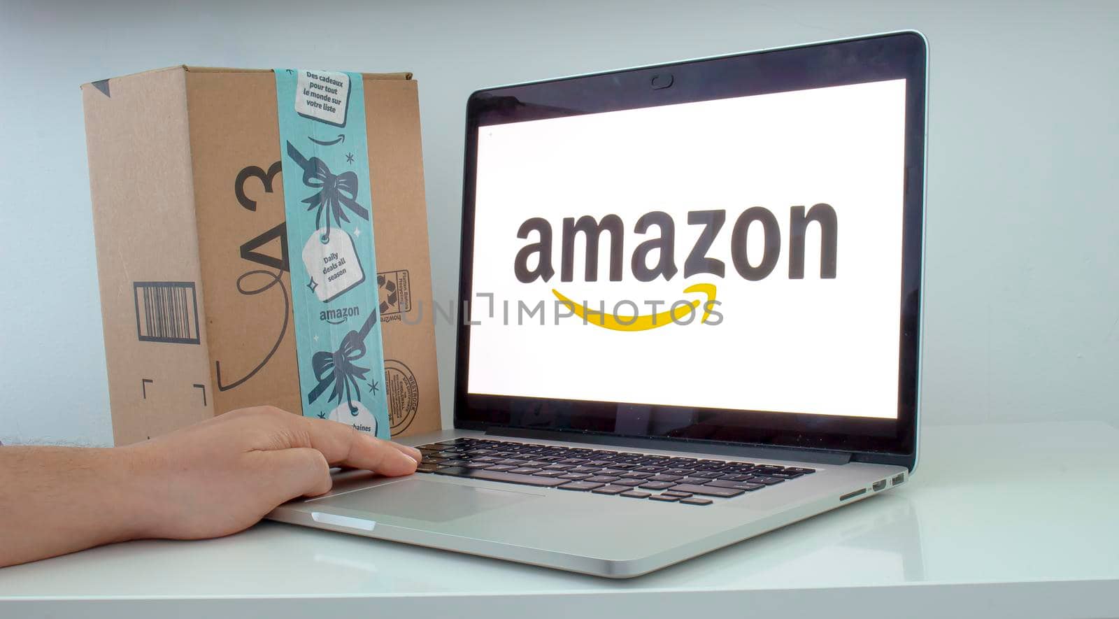 Calgary, Alberta. Canada Dec 11 2019: A Person’s hand is using an apple computer on amazon. Amazon’s fight with US president is about much more than $10bn. Illustrative