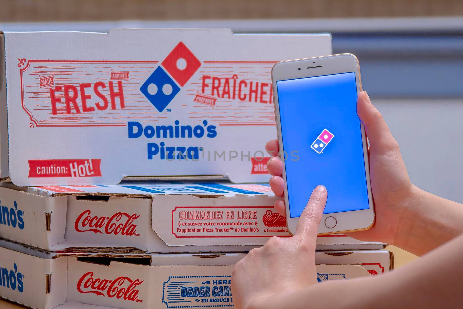 Calgary, Alberta. Canada Dec 26, 2019. Close up of a person using the Domino’s Pizza application on an iPhone Plus. Domino’s Pizza sticking to growth plan despite sales pressures. Illustrative by oasisamuel