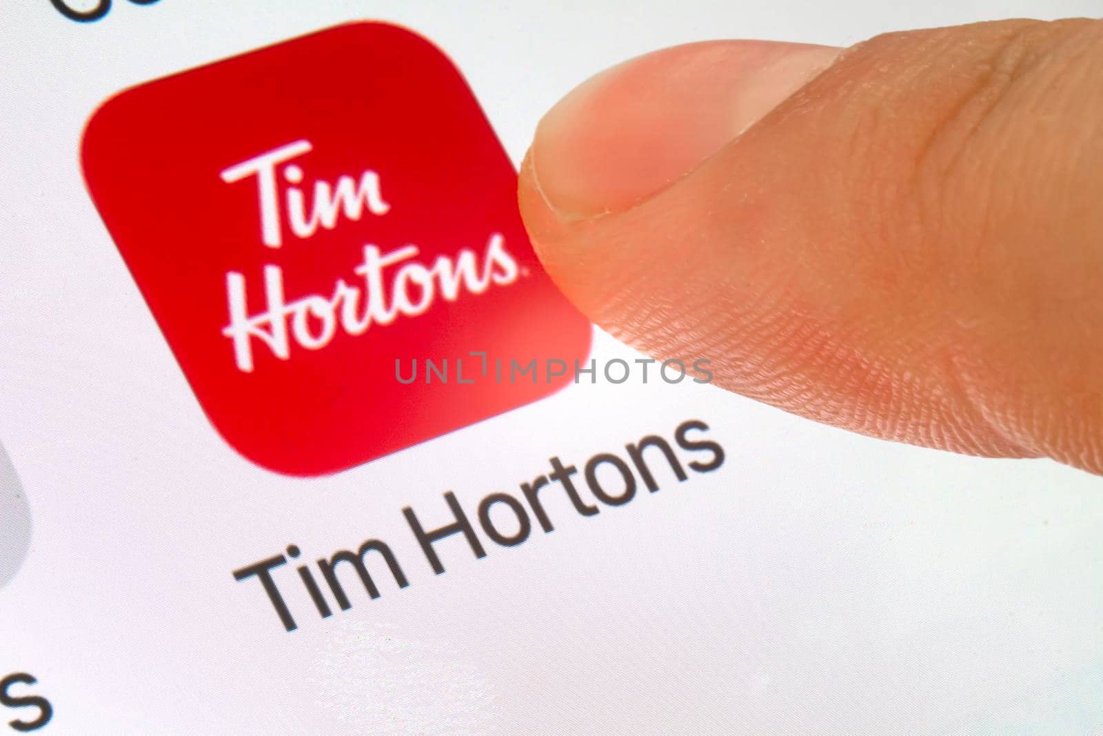 Calgary, Alberta. Canada. March 6, 2020. A person using the Tim Hortons app. Illustrative
