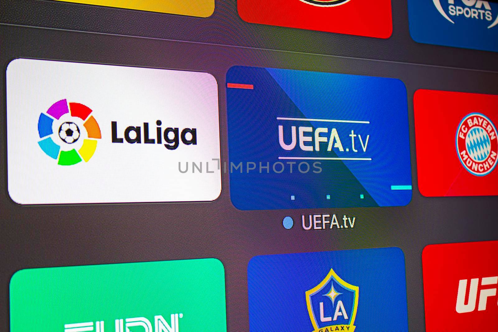 Calgary, AB, Canada. June 11, 2020. Close up of an An apple tv with the UEFA and la Liga application. Concept watching soccer european football. by oasisamuel