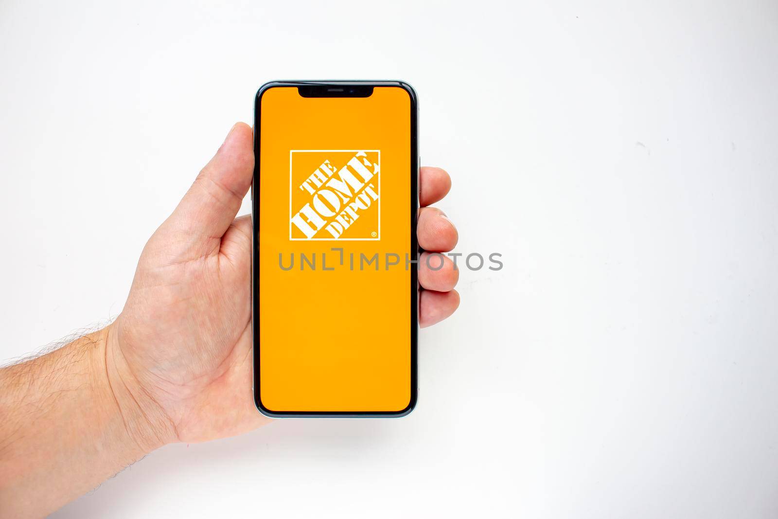 Calgary, Alberta, Canada. Aug 15, 2020. A person holding an iPhone 11 Pro Max with the Home Depot App by oasisamuel