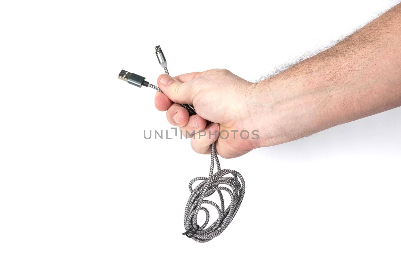 Hand holds USB cable on white background, template for designers by vizland