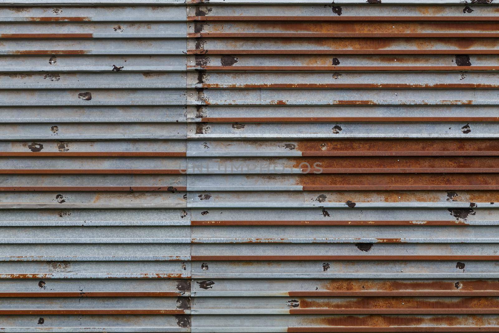 rusted corrugated steel sheets with leftovers of zync plating background and texture.