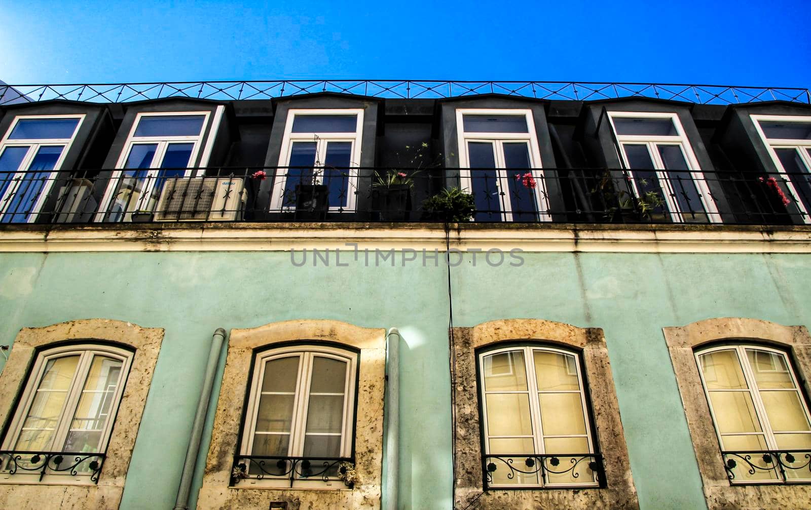 Old colorful houses and streets of Lisbon, Portugal in Spring. Majestic facades and old street lights.