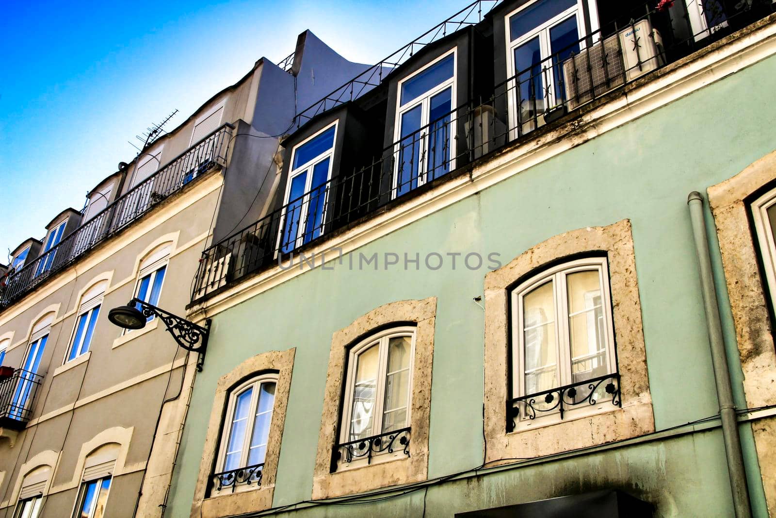 Old colorful houses and streets of Lisbon, Portugal in Spring. Majestic facades and old street lights.