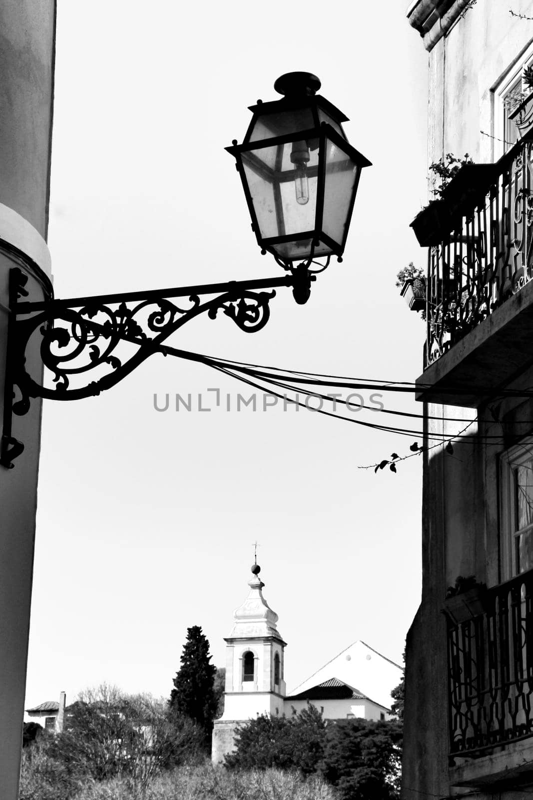 Old colorful and beautiful facades with vintage streetlight in Lisbon streets in Spring.