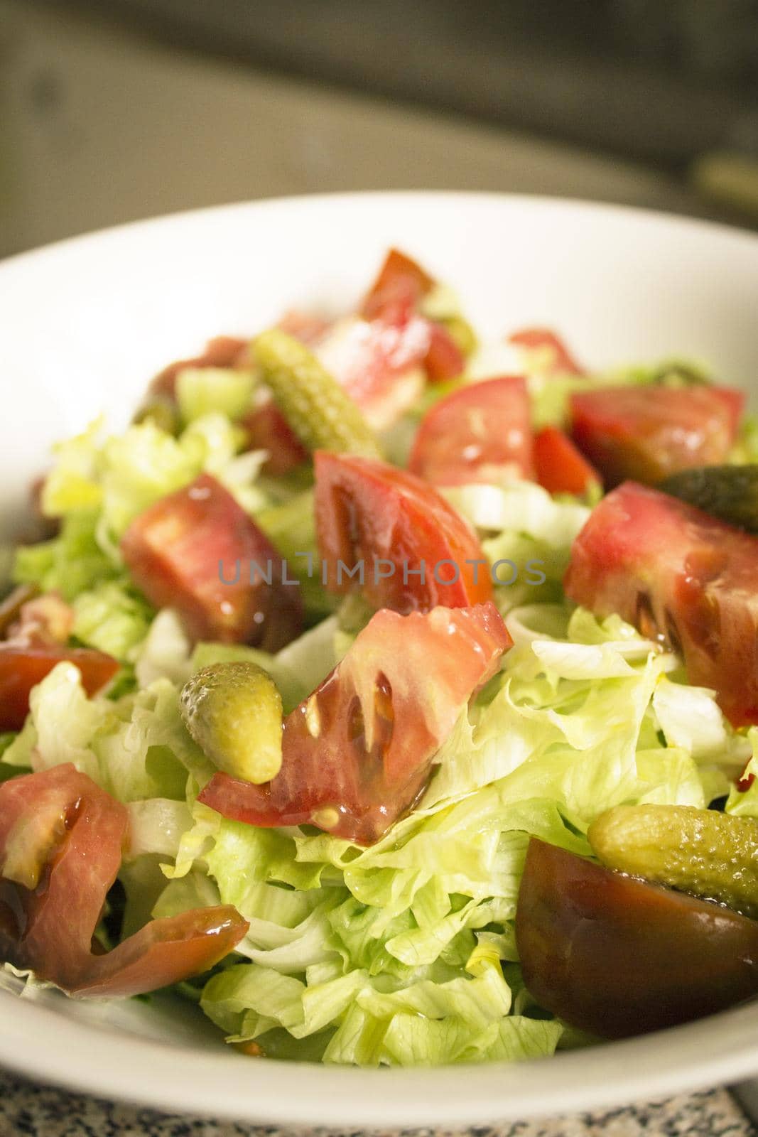 Lettuce salad with tomato and pickles. Raw food