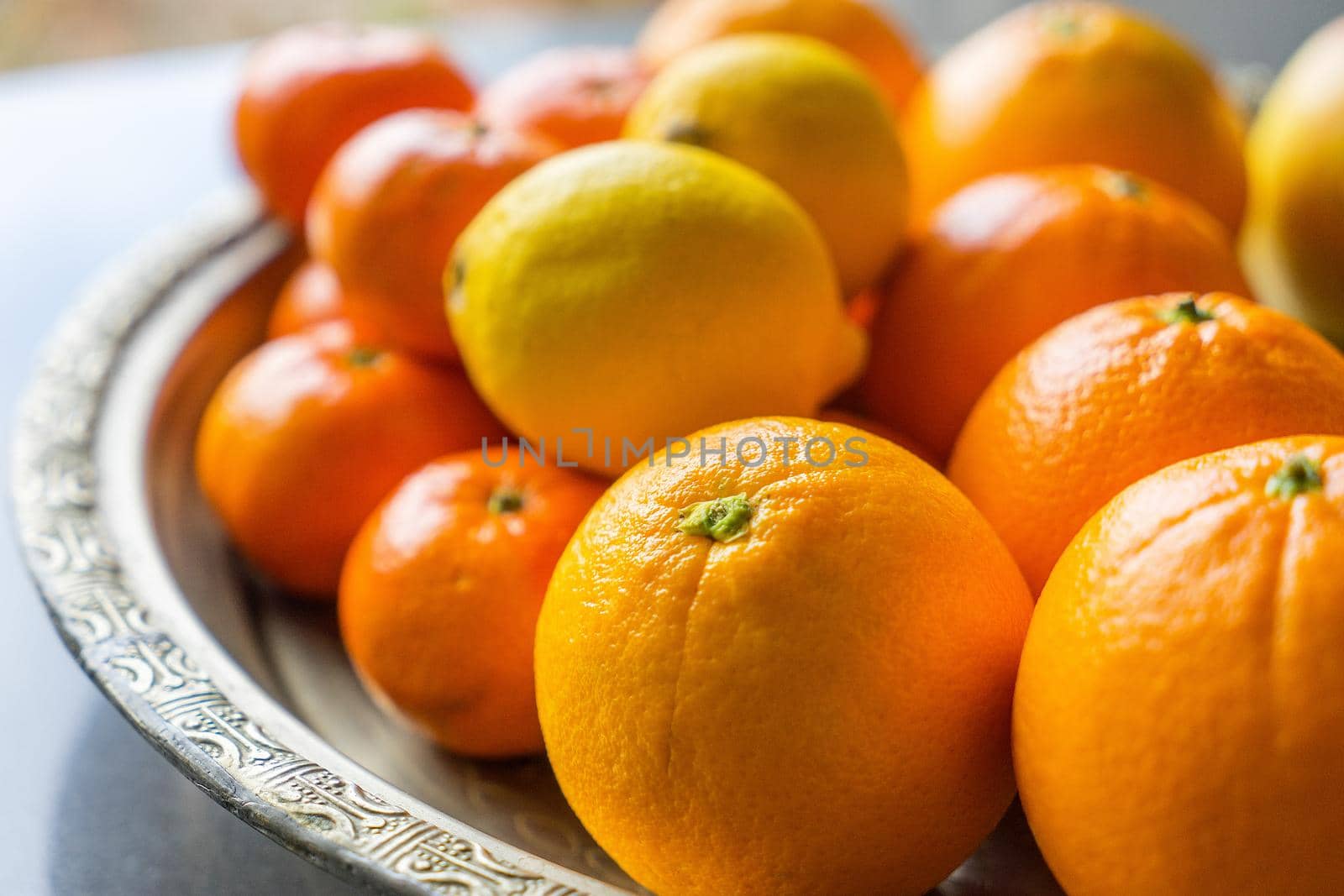 Bowl with fresh citrus fruit, oranges, limes, tangerines