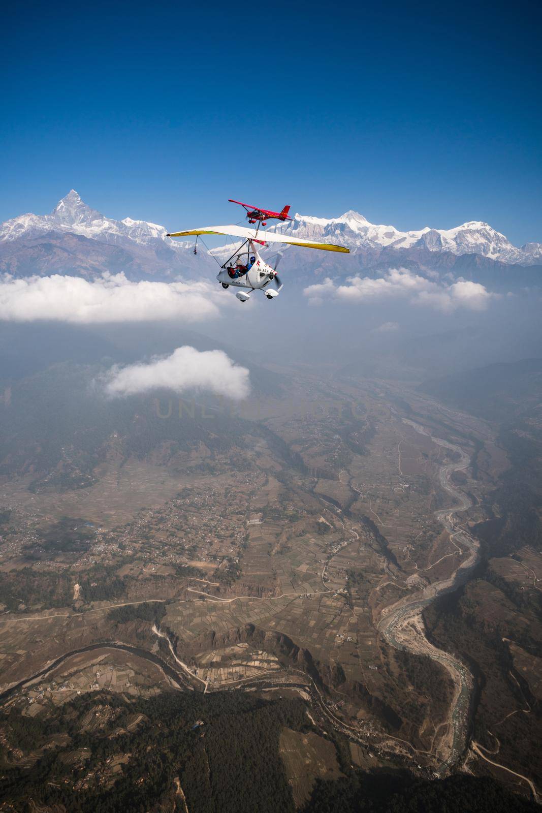 Ultralight trike and plane fly over Pokhara and Annapurna region by Arsgera