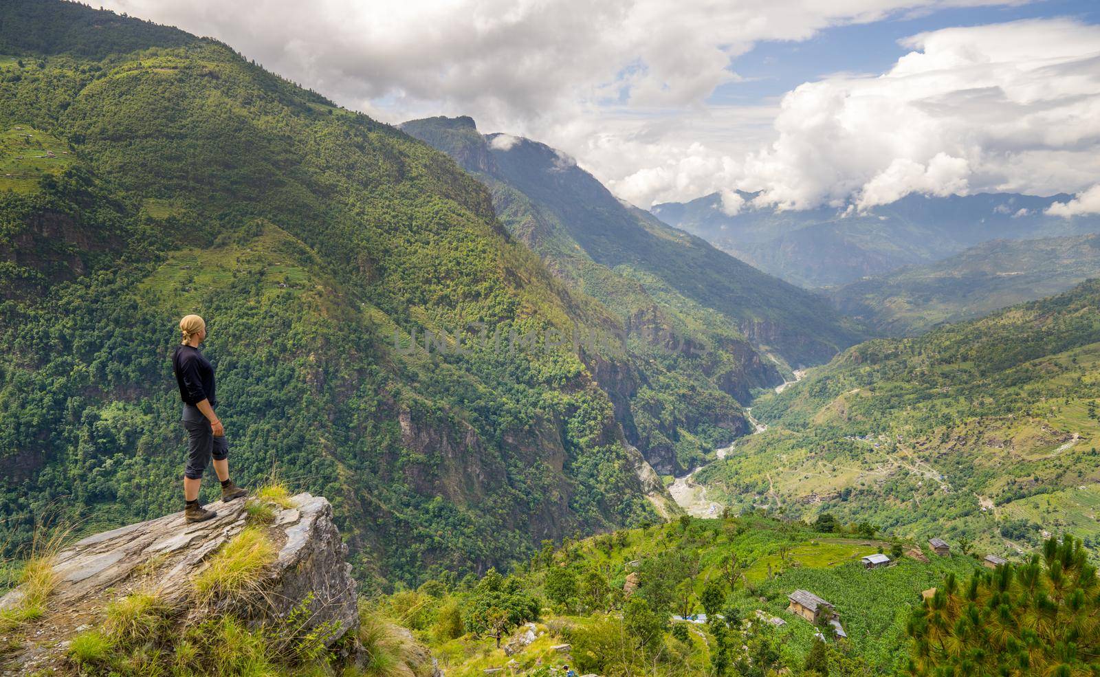 Man standing on top of the hill in Himalayas. Achievement and success. Trekking in Nepal