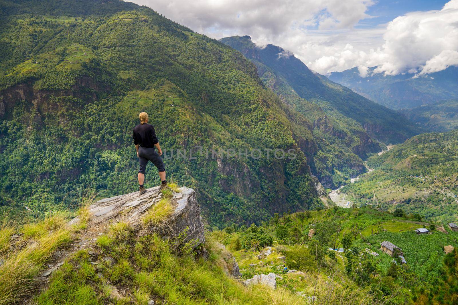 Man standing on top of the hill in Himalayas. Achievement and success. Trekking in Nepal