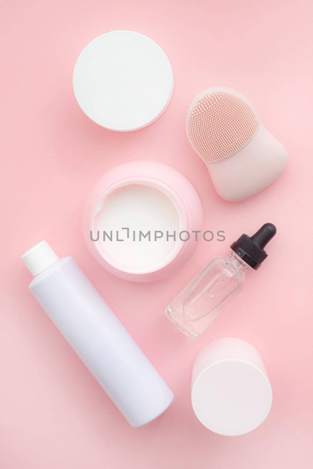 Layout on a pink cream background . Cosmetology. Care cosmetics. Skin care. Jars of cream. Pink background. Copy space. Article about the choice of cream. Spa. Spa treatments .