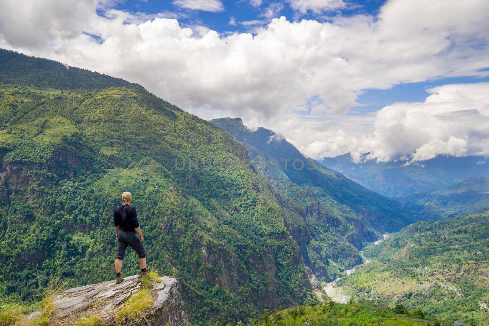 Man standing on top of the hill in Himalayas. Achievement and success. Trekking in Nepal