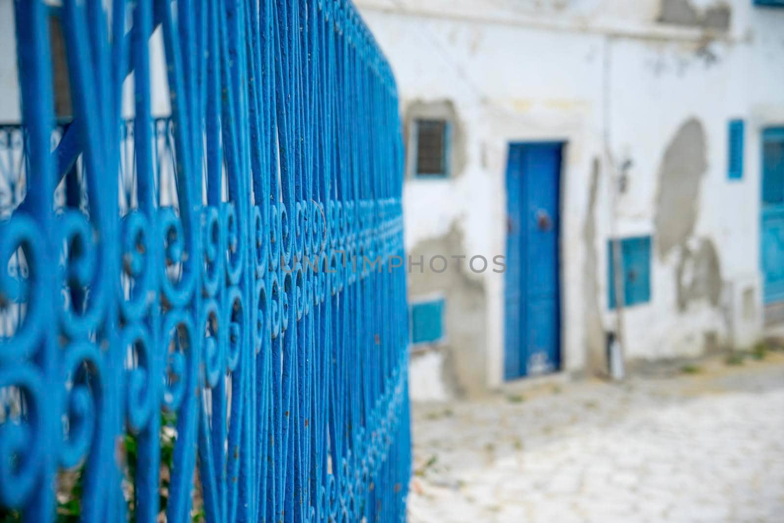 Aged Blue doors and windows in Andalusian style from Sidi Bou Said in Tunisia