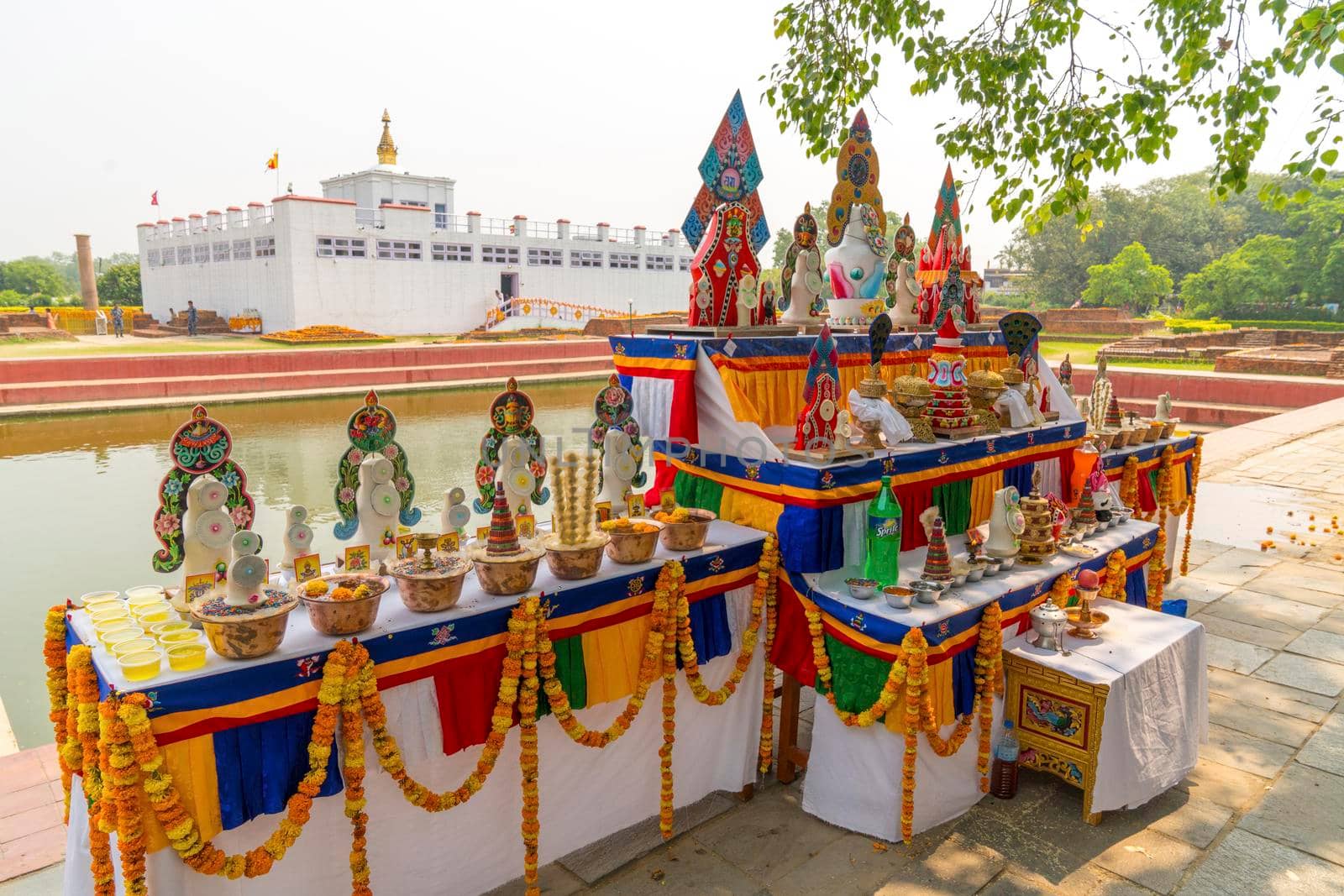 Buddha birthplace in Lumbini and buddhist offerings near sacred pond. Captured in Nepal, spring 2018