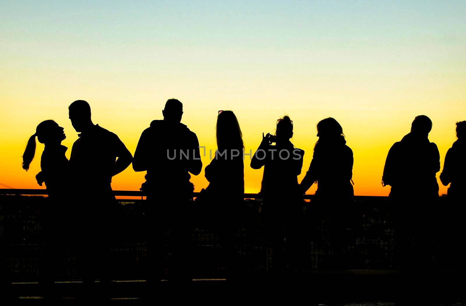 Lisbon, Portugal- November 6, 2017: People watching a beautiful sunset in a viewpoint of Lisbon in Autumn