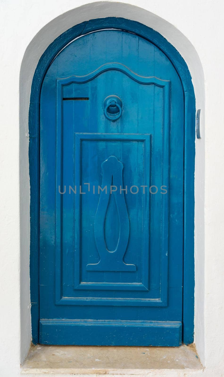 Blue door with ornament and arch from Sidi Bou Said in Tunisia