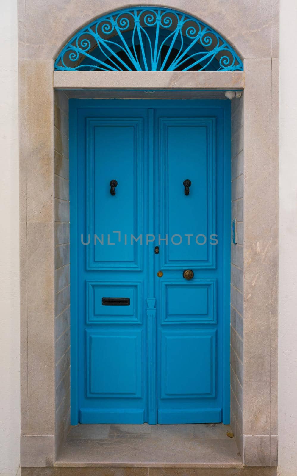 Blue wooden door with arch from Sidi Bou Said by Arsgera