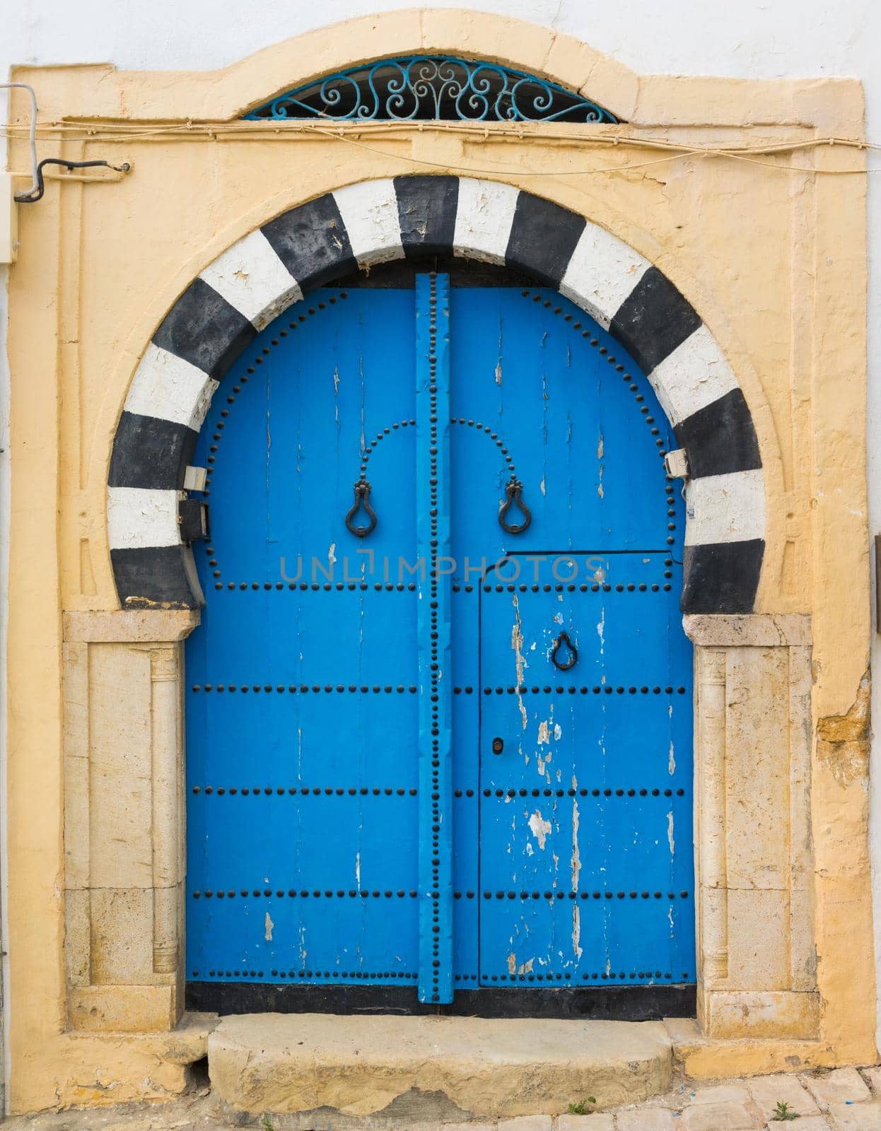 Traditional blue arched door from Sidi Bou Said by Arsgera