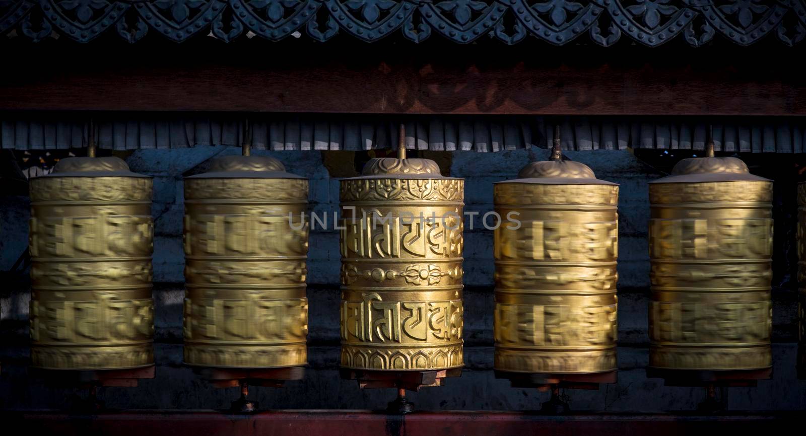 Buddhist shiny prayer wheels rotating in motion. Nepal, Kathmandu