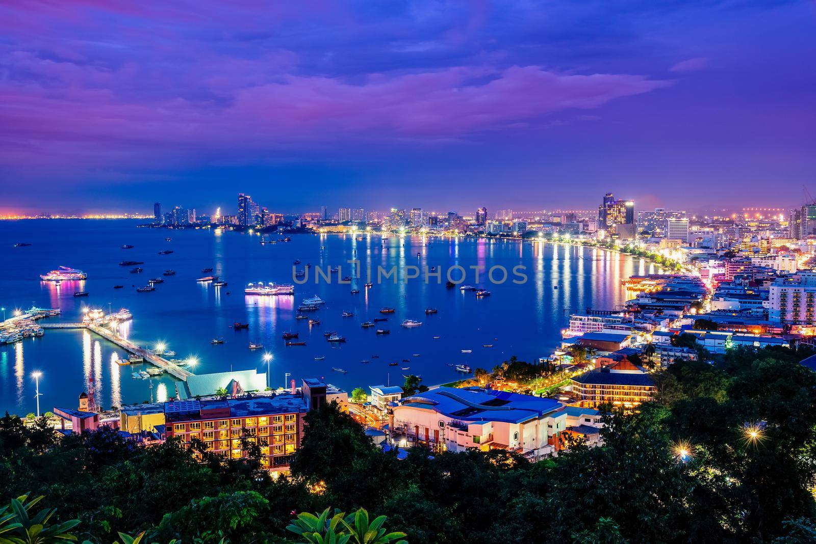 High view on viewpoint see cityscape with colorful light at the beach and the sea of Pattaya Bay, beautiful landscape of Pattaya City at night scene landmark in Chonburi, Travel Asia to Thailand