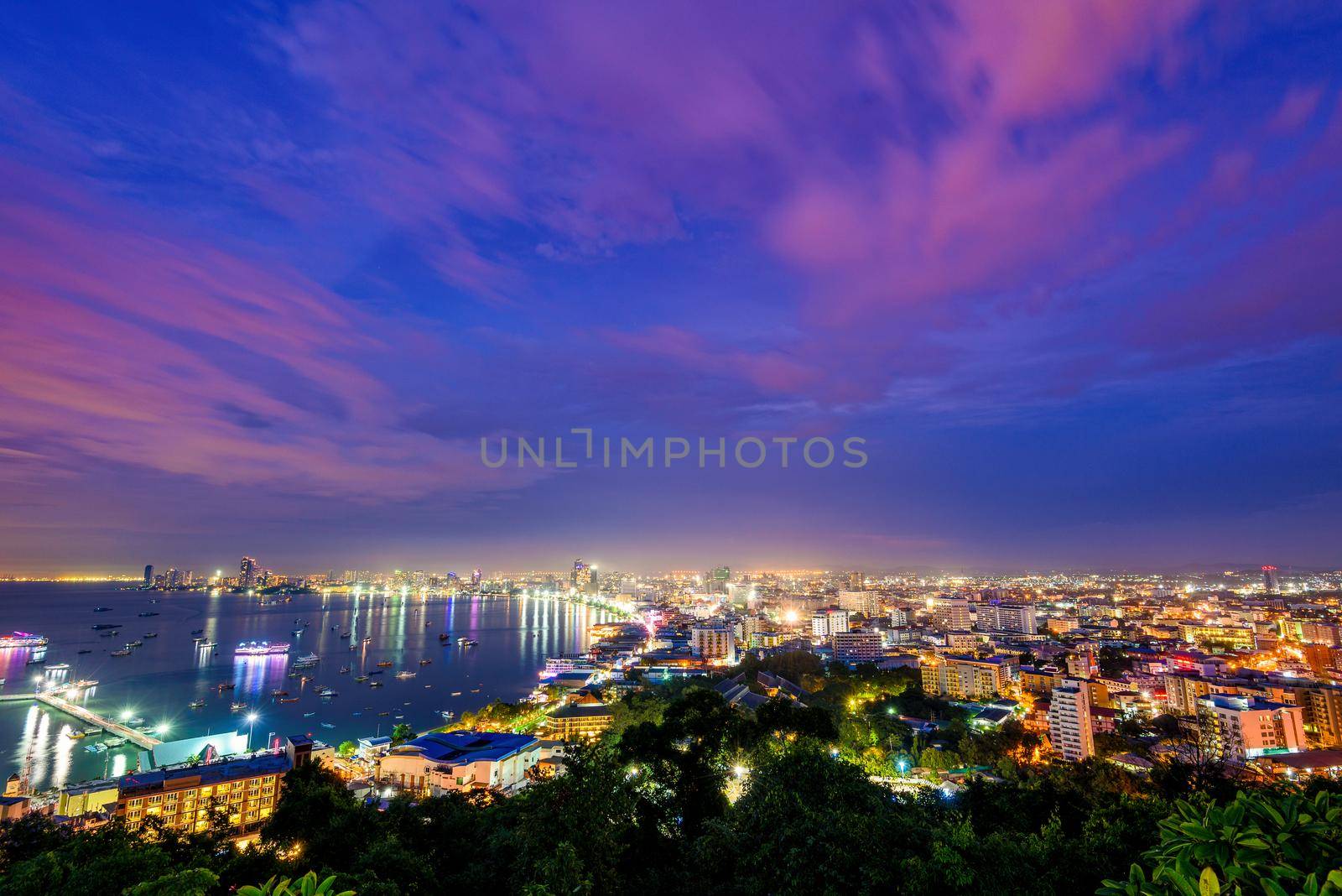 High view on viewpoint see cityscape with colorful light at the beach and the sea of Pattaya Bay, beautiful landscape of Pattaya City at night scene landmark in Chonburi, Travel Asia to Thailand