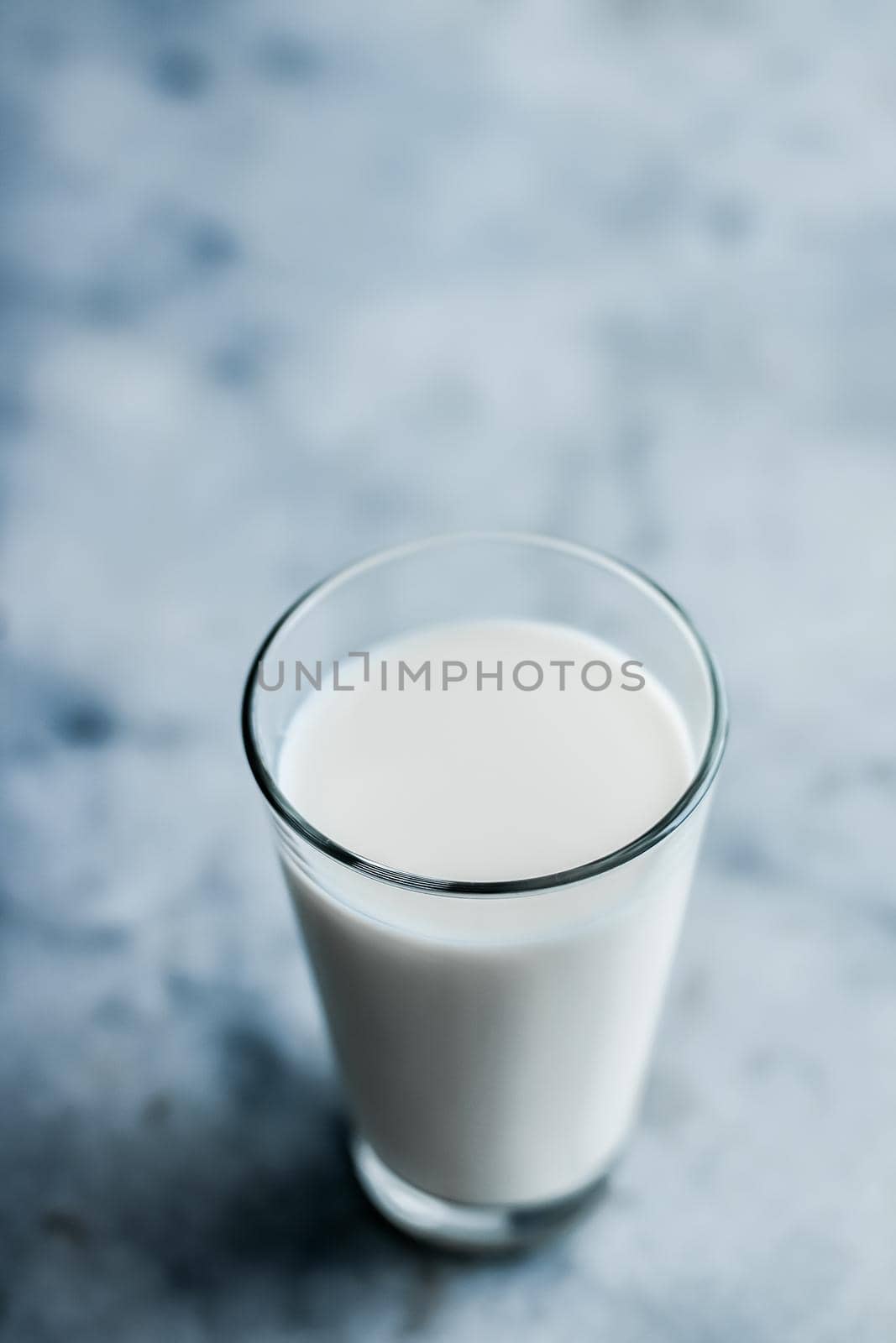 Dairy, healthy nutrition and breakfast concept - World Milk Day, full glass on marble table