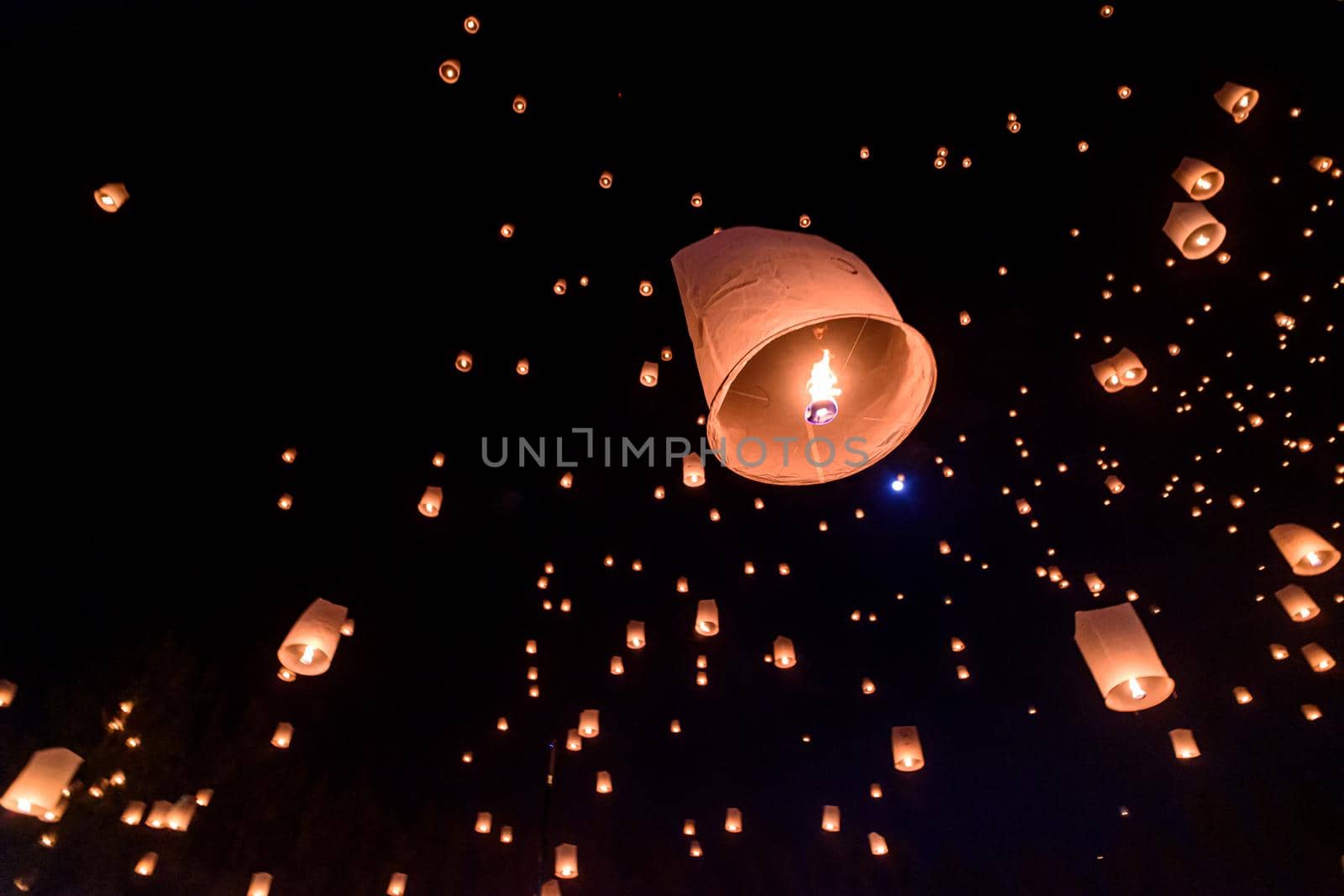 Floating lanterns on sky in Loy Krathong Festival  by NuwatPhoto