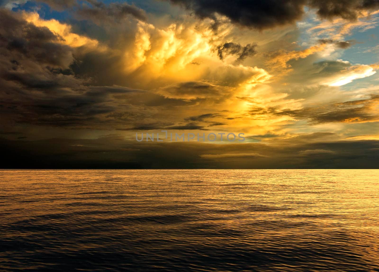 Background sea in the evening sky with golden clouds.