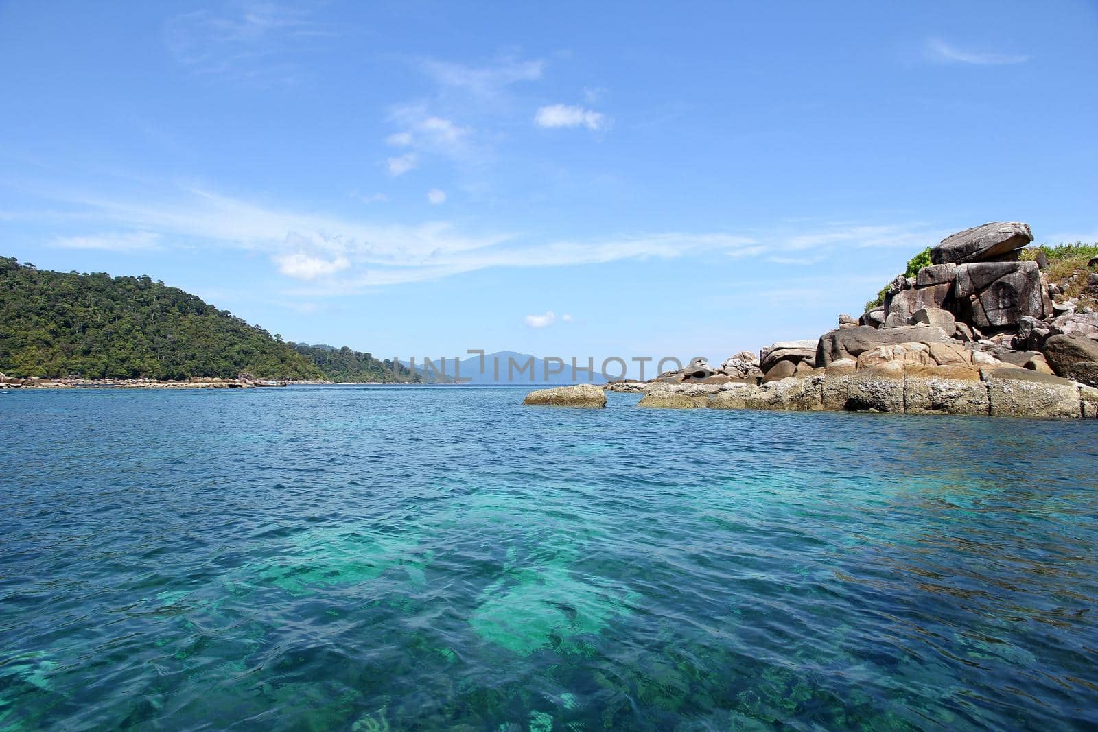 The coastal water green with sky blue coral islands.