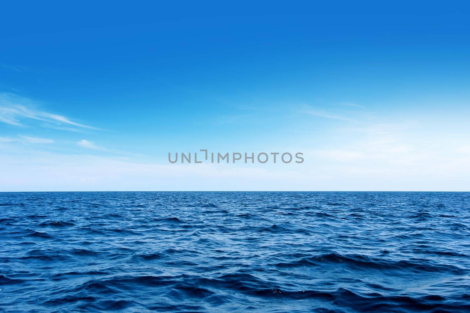Blue sea with waves and wind. And the sky as background.