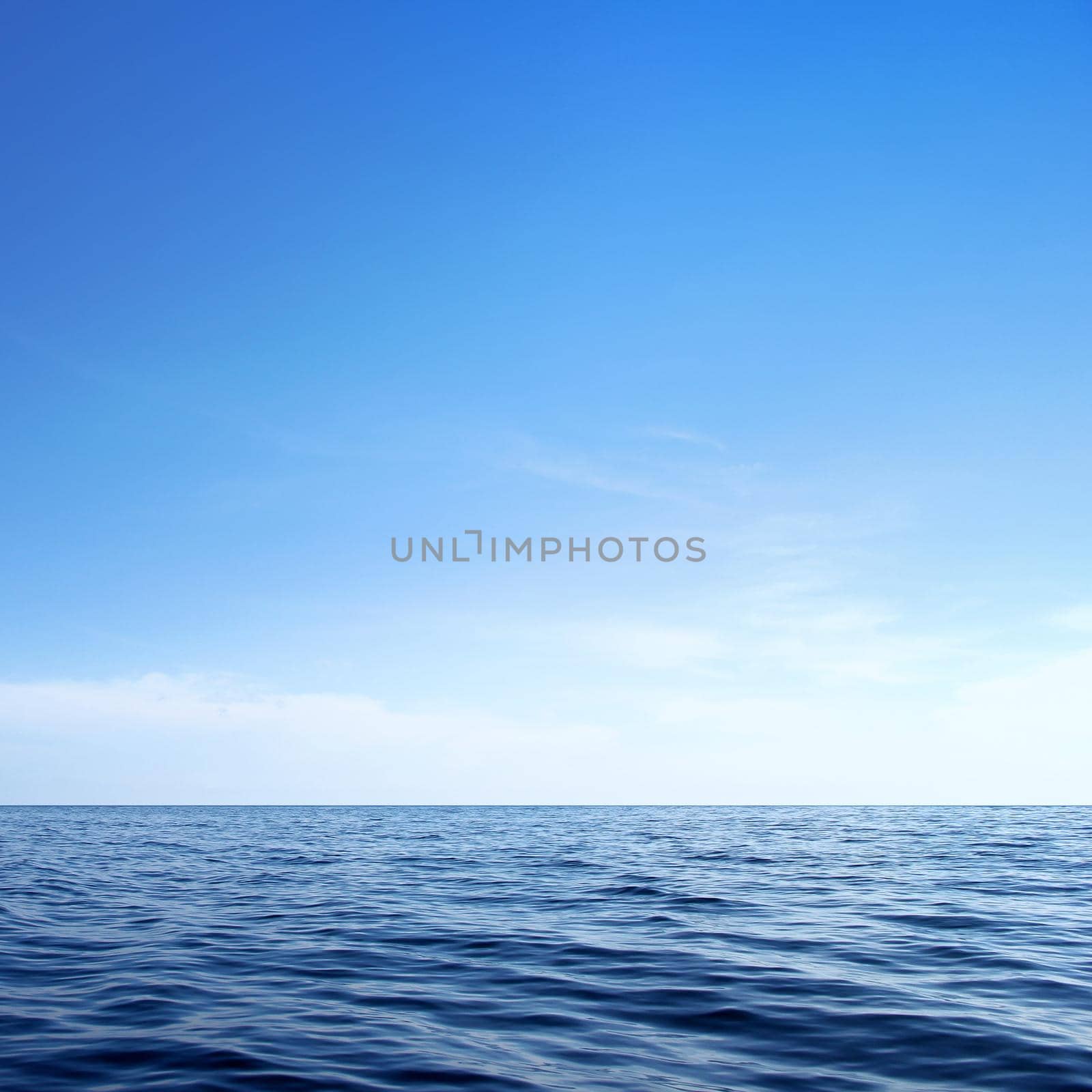 blue sea and cloudy sky over it