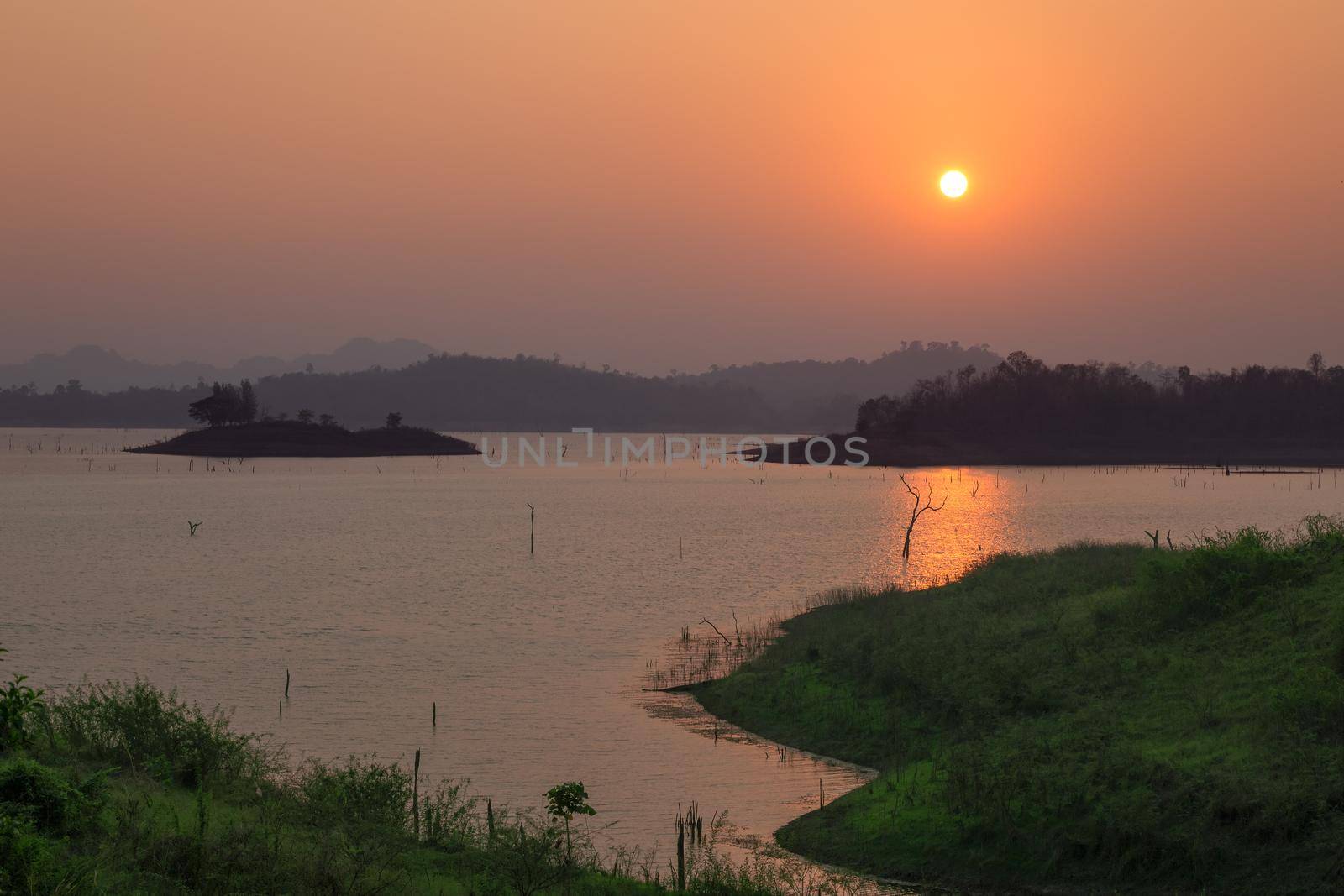 Sunset at the lake with a beautiful orange light. Pompey, Kanchanaburi, Thailand.