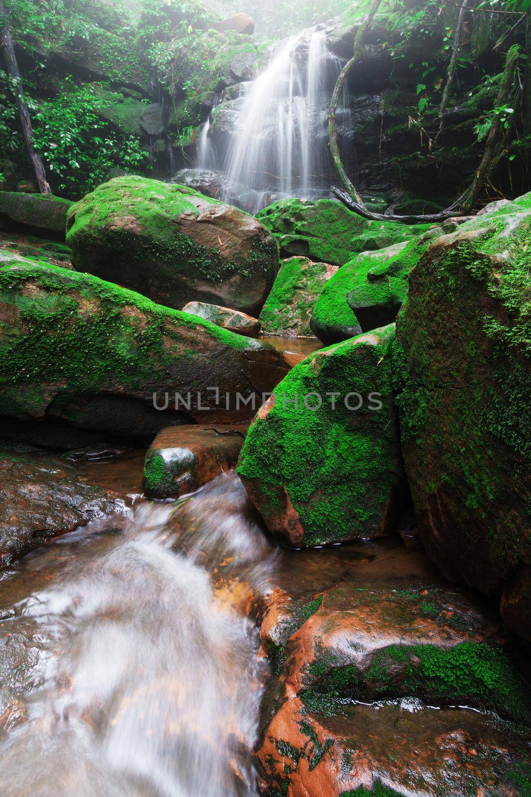 Saithip waterfall in Phu Soi Dao National Park, Thailand. A small waterfal with beautiful scenery of lush rocks and forest line