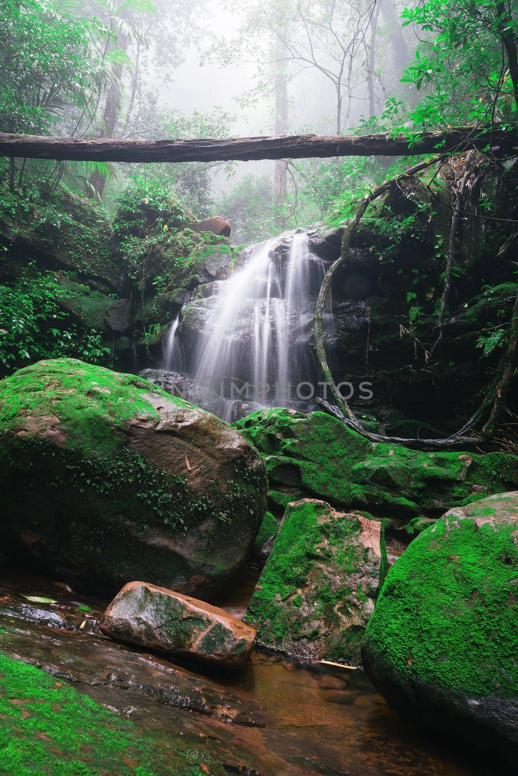 Saithip waterfall in Phu Soi Dao National Park, Thailand. A small waterfal with beautiful scenery of lush rocks and forest line