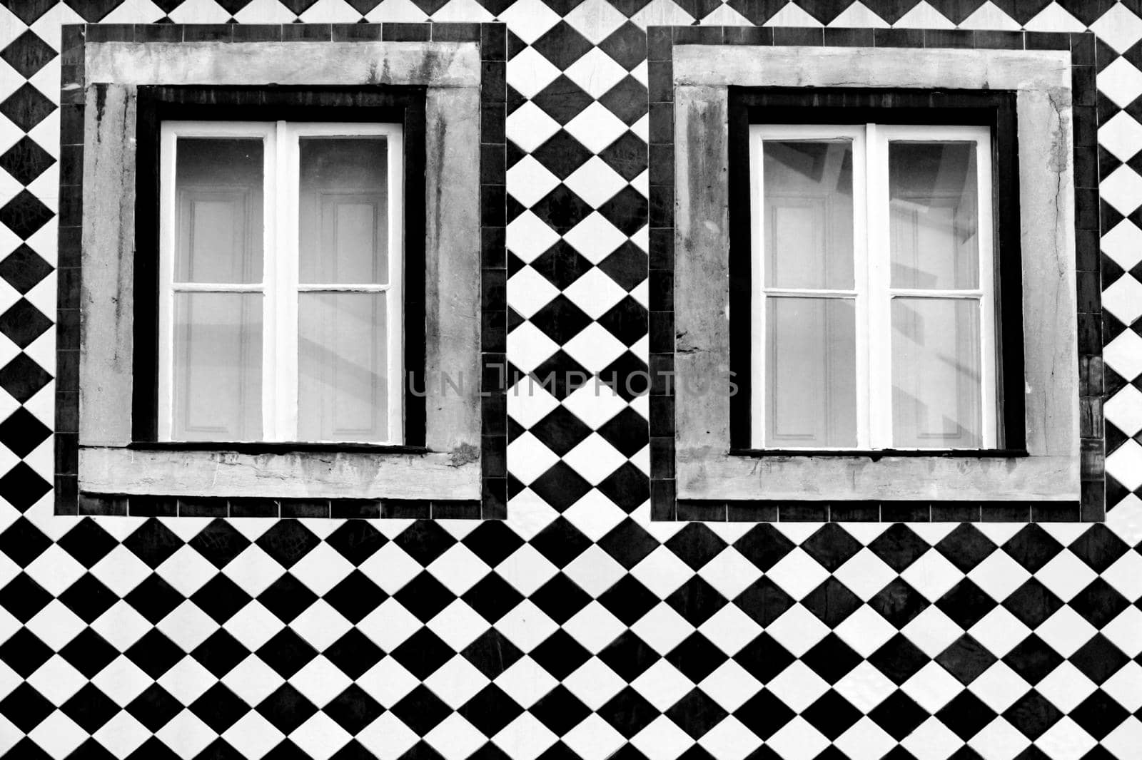 Old colorful and bright typical facade in Lisbon with beautiful vintage wooden window