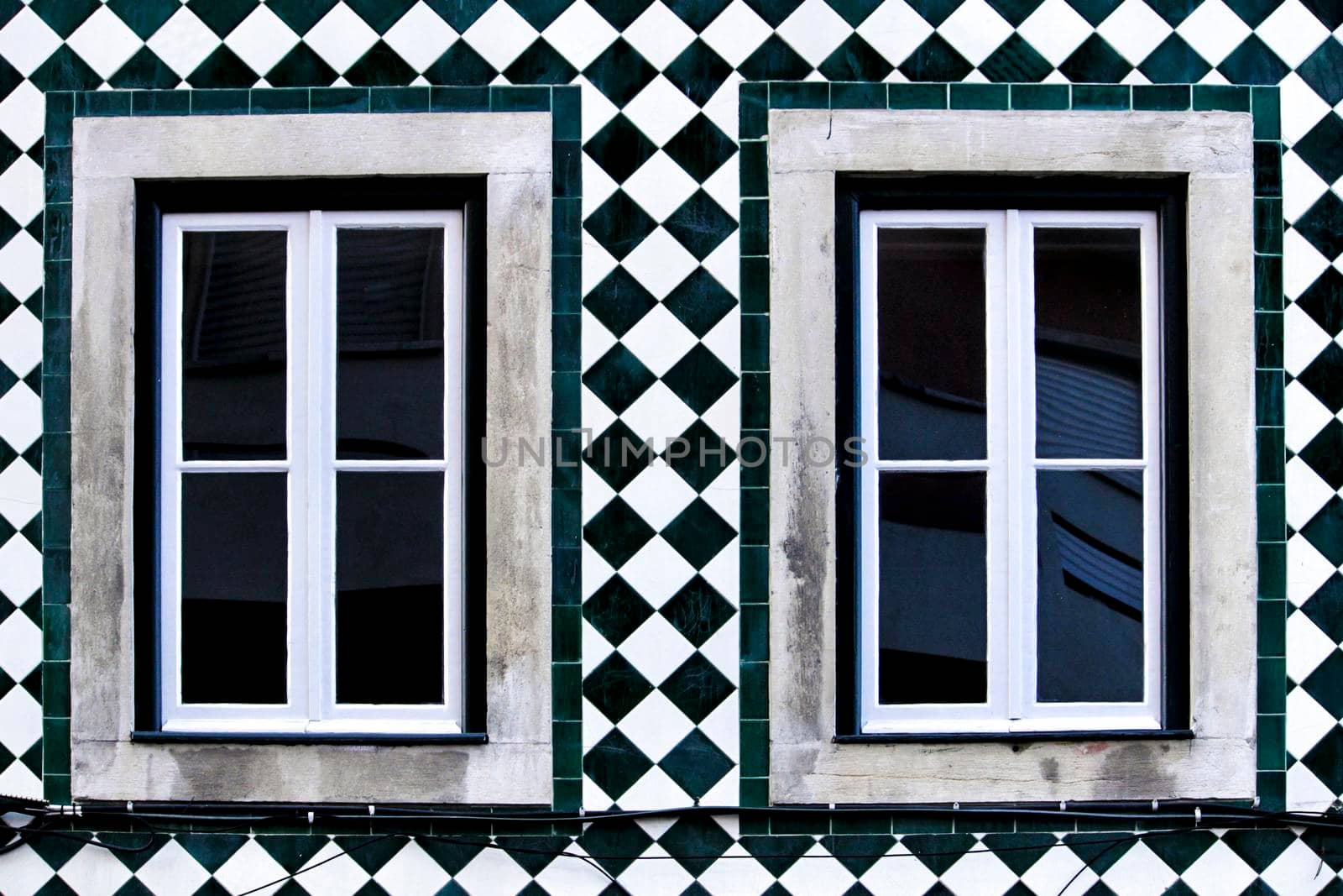 Old colorful and bright typical facade in Lisbon with beautiful vintage wooden window