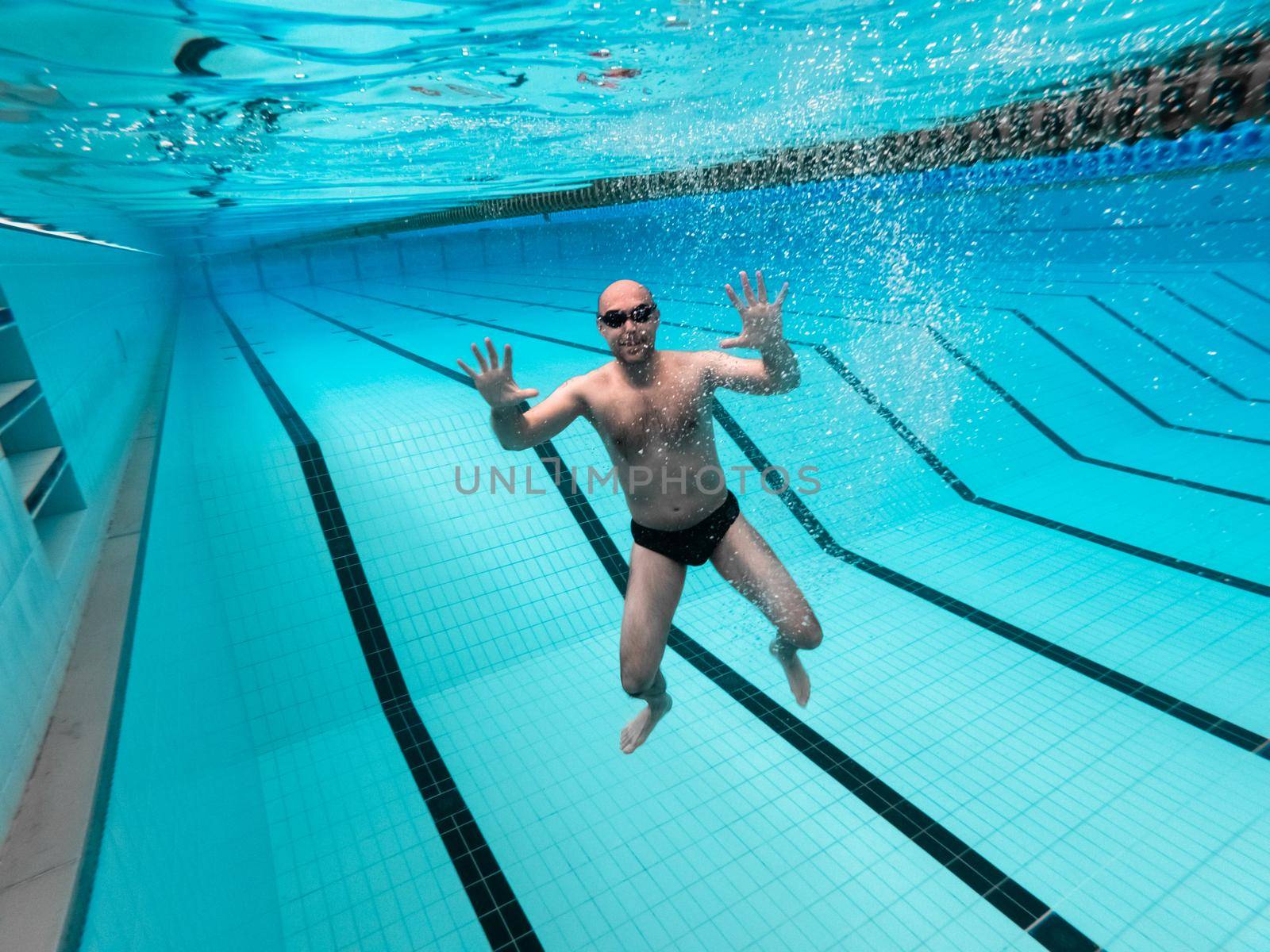 swimming in the pool at the swimming stadium.