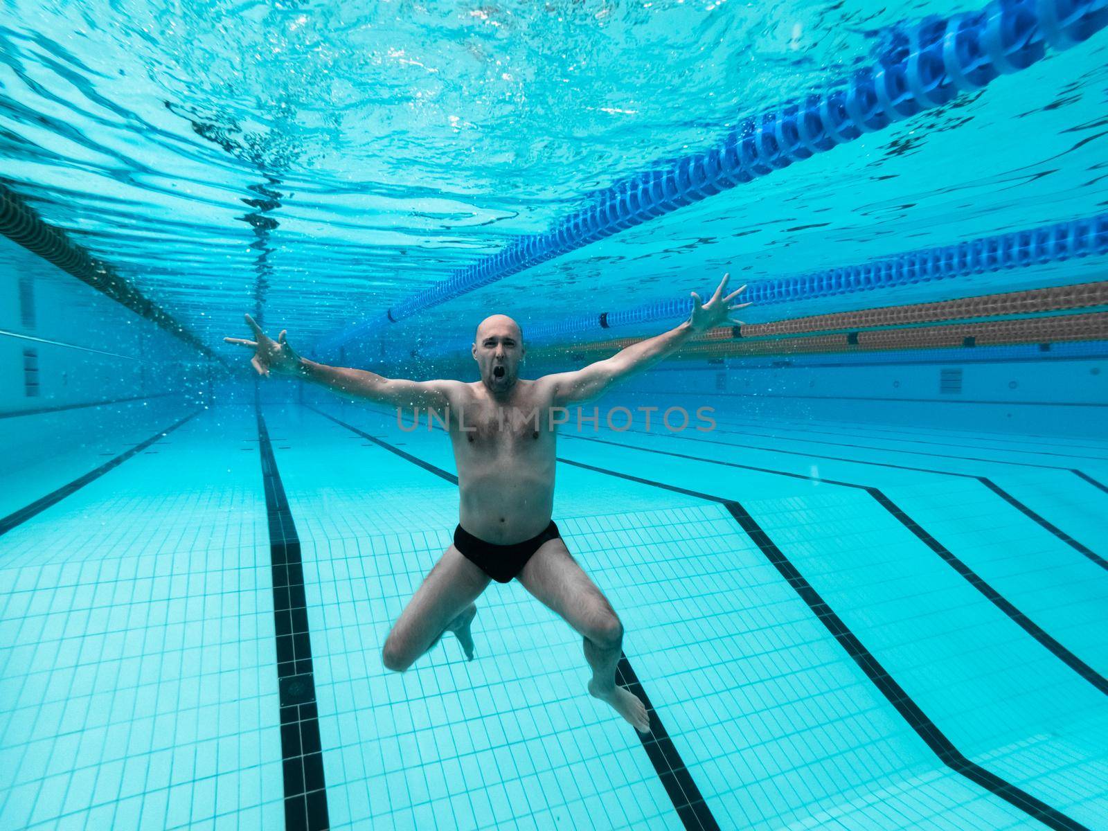 swimming in the pool at the swimming stadium.