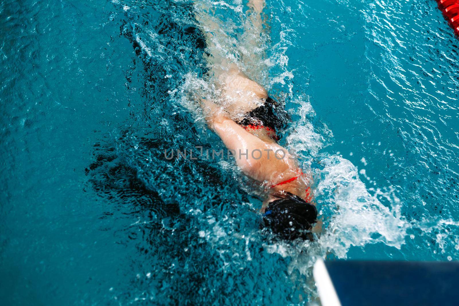 swimming in the pool at the swimming stadium.