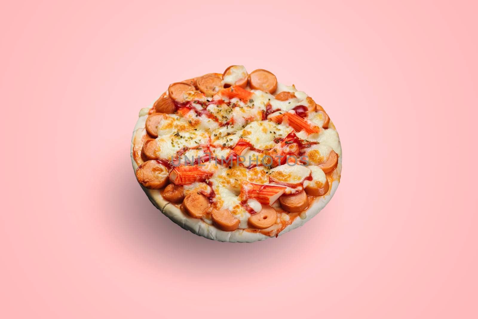 Sausage and Crab Stick Pizza isolated on pastel color background.