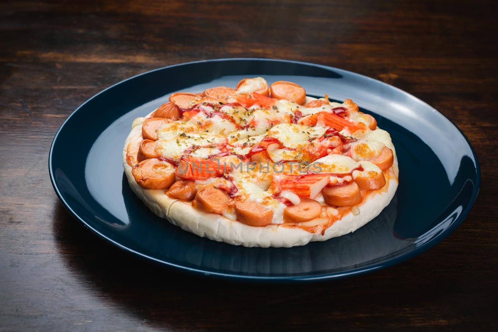 Pizza, sausage and crab sticks in a ceramic plate. by wattanaphob