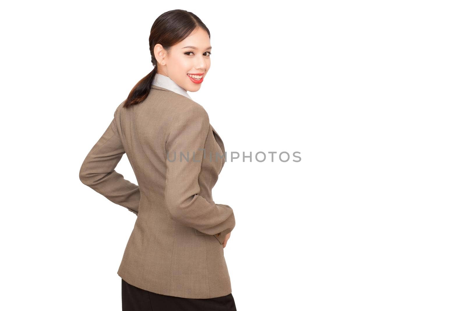 Pretty businesswoman pointing. Isolated on white.