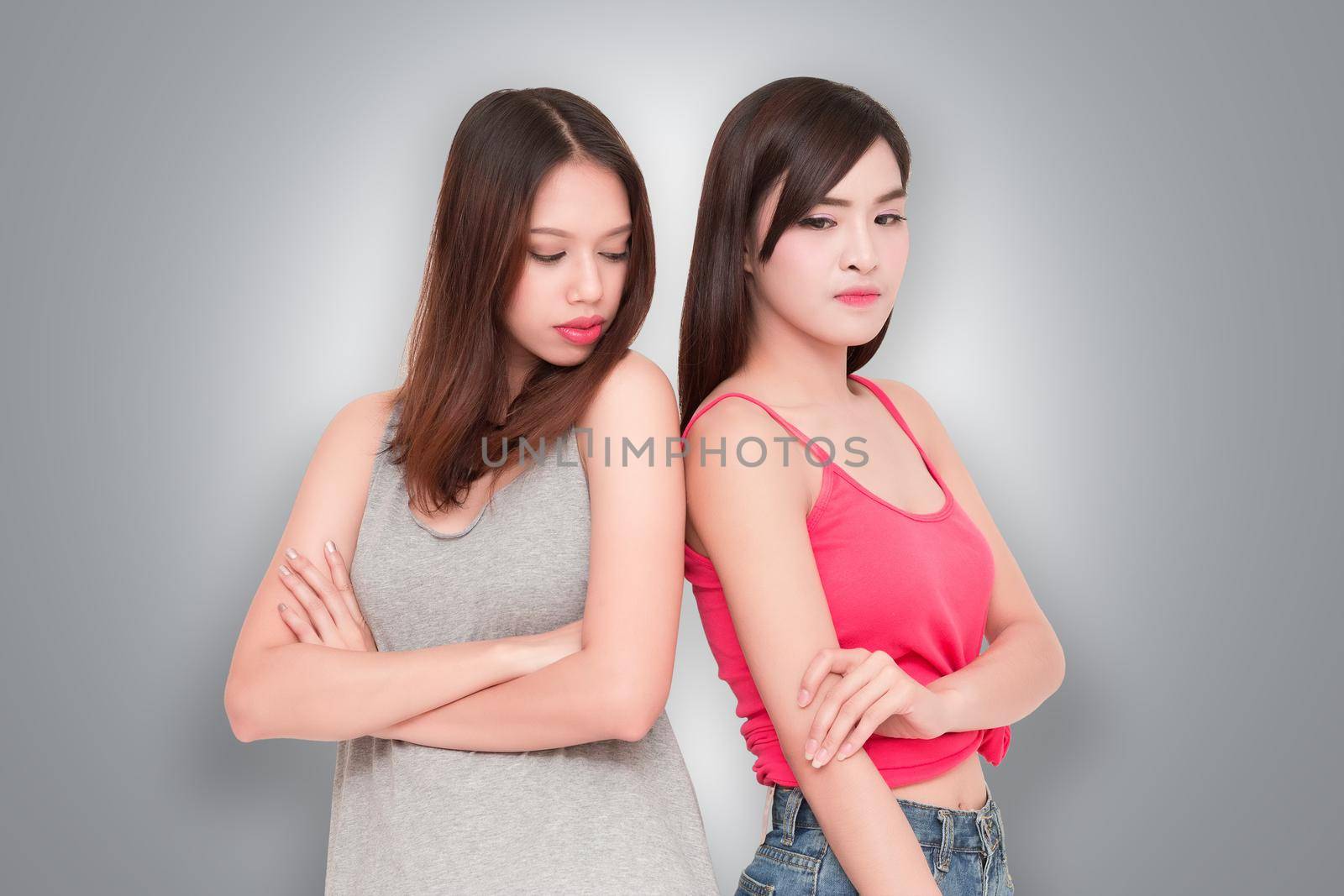 Two girls looking each other angry 