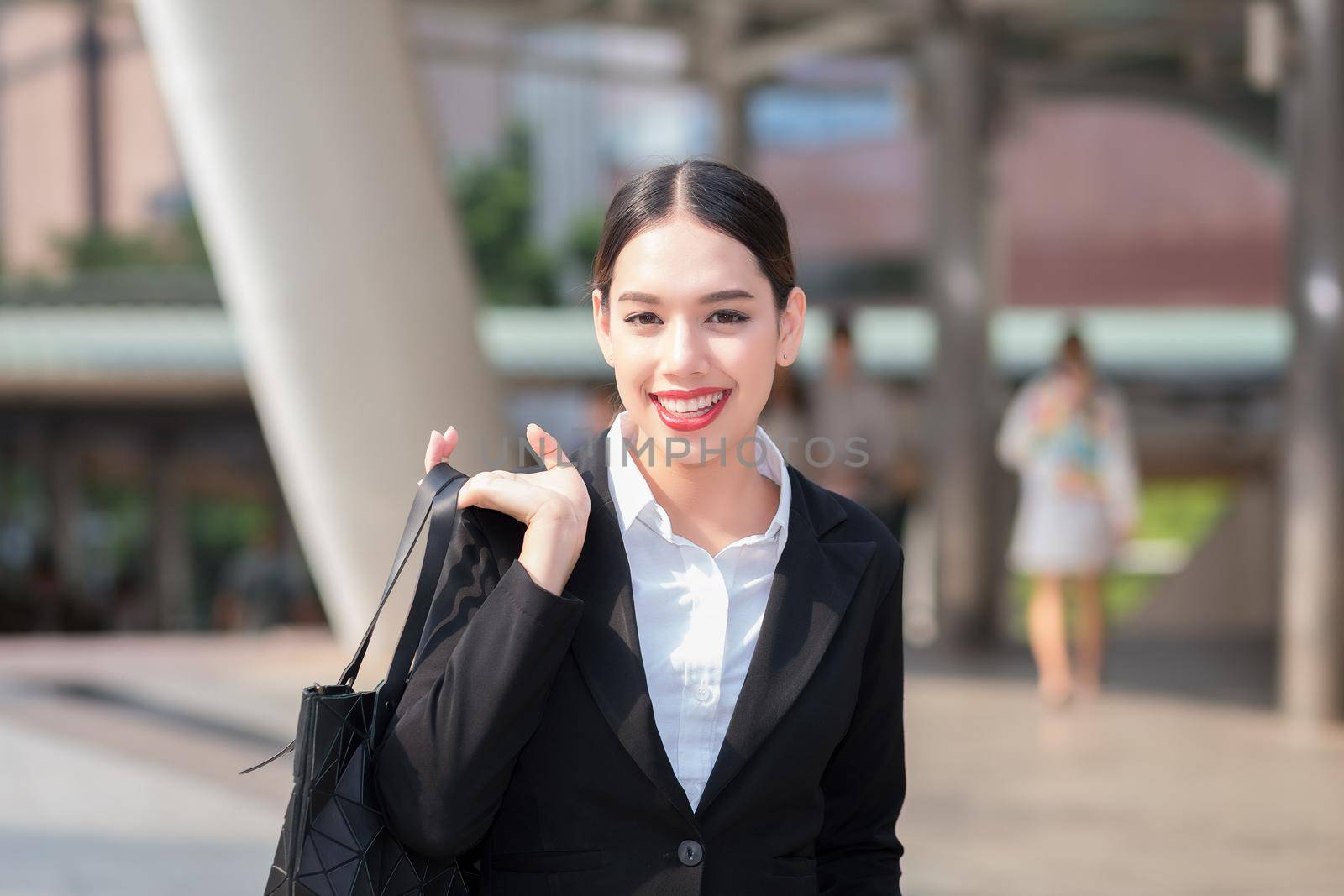 Young business woman in the big city purposefully looking away.